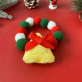 Macro shot of Christmas pet collar with red green plush balls and yellow bell bow - Xmas Bell Figure Collar