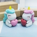 Cute pink and blue unicorn cake toppers holding hearts, handmade resin birthday decor - Blue Holding Heart And Pink Holding Heart