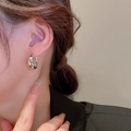 Close-up of a silver-finish twisted C-shaped earring showing polished metal texture - 32# Silver Twisted C-shaped Hoop (Silver Earring Post)