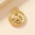 Vista dettagliata di un ciondolo segno zodiacale Toro placcato oro 18K su fondo beige - Toro