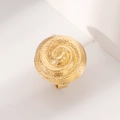 Macro shot of gold spiral ring with textured surface in a minimalist luxury style - Gold Spiral Textured Ring (0650)