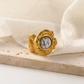 Macro shot of 18k gold snake ring with white turquoise on beige travertine stone - US 7 / Gold White Turquoise