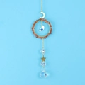 Macro detail of suncatcher crystal pendant with red agate stones and golden metal stars - Agate