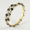Bracelet manchette spirale dorée orné de zircons cubiques noirs et transparents - Blanc et Noir