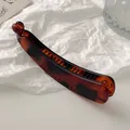 Matte amber tortoiseshell banana hair clip with non-slip teeth for voluminous hair styling - Amber