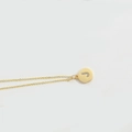 Minimalist gold necklace with a circular pendant featuring a sparkling crystal letter J - Letter J