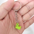 Cute green resin duck keychain with silver ring held in hand for size perspective - 25mm Ring / Green