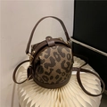 Fashionable leopard print bucket bag with brown leather trim and top handle strap - Dark Brown