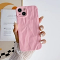 Pink wrinkled silicone case for iPhone with protective soft texture in hand detail view - Pink