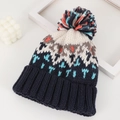 Detail of navy knit beanie with colorful wave patterns and large multicolor faux fur pompom - M (56-58cm) / Navy Blue