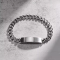 Macro detail of silver stainless steel curved bar on a chunky curb chain bracelet - Magnetic Cuban Bracelet / Steel
