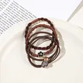 Close-up of brown elastic hair bands with heart and flower charms on a ceramic tray - 4Pcs Set - Heart Style / Brown