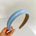 Detailed view of the blue faux leather padded headband with contrast brown lining texture - Blue