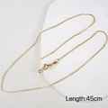 Polished 45cm gold box chain necklace with lobster clasp shown on white marble display - Gold Adjustable Box Chain Necklace 45cm