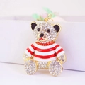 Golden teddy bear keychain with sparkling crystals and red striped sweater accessory - Red Stripe