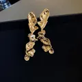 High-quality close-up detail of vintage gold irregular liquid metal texture earrings on box - Minimalist Cold Style Stud Earrings (12#)