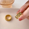 Detail view of gold rings with cartoon gingerbread man motifs and love you engraving - Graffiti Gingerbread Man Open