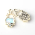 Detailed close-up of heart charm with blue resin inlay and elegant pearl butterfly bow - Gold Base Blue