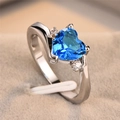 Elegant heart-shaped blue zircon ring with silver metal band on a beige velvet box - US 7 / Silver Tone Sky Blue Zirconia