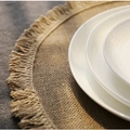 Natural round jute placemat with fringe detail and white ceramic plates on top - 38cm / Natural Color