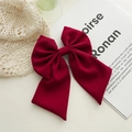 Close-up of elegant burgundy oversized bow hair clip made of premium plain fabric - Burgundy