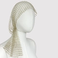 Close-up of champagne gold mesh headpiece with shimmering crystal beads on mannequin - Gold
