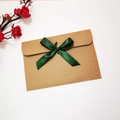 Brown kraft paper envelope with dark green silk ribbon bow for elegant gift wrapping - Envelope with Dark Green Ribbon