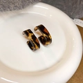 Top view of C-shaped leopard print resin earrings on a white ceramic plate - 32# Steel Pin - Brown Leopard (Acrylic C-Shape)