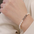 Natural freshwater pearl bracelet with gray stones and gold beads on a woman's wrist - Pearl and Grey Stone Bracelet (J-f-030)
