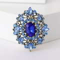 Vintage gold brooch with navy blue oval rhinestone and light blue crystals inlay - Blue