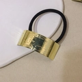 Sleek gold-tone U-shaped metal ponytail holder with brushed texture and black elastic band - Brushed Arc - Gold