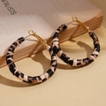 Detailed view of leopard print hoop earrings on vintage book with golden metal clasp - Hoop Earrings - Coffee Brown - Round (4cm)