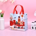 Blue Christmas non-woven gift bag featuring nutcracker and holiday train illustrations - Light Blue Soldier