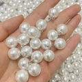 Macro view of white faux pearl charms with silver metal caps for jewelry making - Pure White Pearl Silver Eye Pin