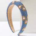 Macro shot of blue padded headband with rhinestones, gold stars and pink pearls - Light Blue