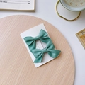 Pair of elegant green satin bow hair clips for girls displayed on a wooden board - Green Bow 2-Piece Set