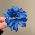 Deep blue silk artificial flower hair clip with creamy white stamens shown in hand - Type B Blue Lily Hair Clip