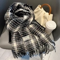 Thick black and white plaid scarf with colorful dots and fringe on a modern chair - Sugar Bean Black