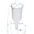 Detailoverzicht van de witte bodysuit met bruine stippen en een open rugpand - S / Beige