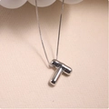 Macro shot of silver-toned puffed letter T pendant with a sleek box chain necklace - Silver (With Necklace) T