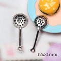 Macro shot of miniature alloy metal skimmers sized 12x31mm for dollhouse DIY projects - Slotted Spoon