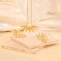 Golden radial wing necklace and earring set displayed on elegant silk and stone - Radiant Leaf Design
