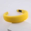 Fashion yellow sponge headband for women with handmade label on minimalist background - Yellow