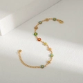 Close-up of golden chain with colorful enamel daisies featuring a secure lobster clasp - Small Flower Bracelet / Colorful