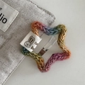Close-up of rainbow star crochet hair clip with a rabbit label and metal snap pin - Star Hair Clip