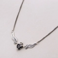 Silver necklace with a black heart gem, tiny crown, and detailed angel wings pendant - Angel Wing Necklace