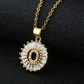Macro shot of gold letter O pendant with baguette and round cubic zirconia stones - Gold Letter O