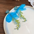 Blue fabric flower tassel earrings with resin heart and colorful beads on white plate - Blue Heart Bow Tassel (25#)