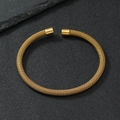 Detailed close-up of golden mesh wire texture on a stainless steel open cuff bracelet - 5mm / Gold