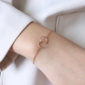 Elegant rose gold interlocking double circle bracelet on a woman's wrist with O-chain - 14+5cm / Rose Gold Bracelet